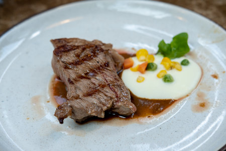 Medium rare meat served on plate on the tableの写真素材