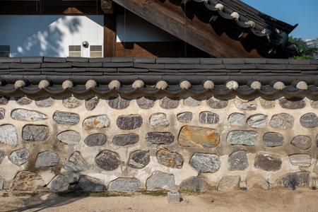 Traditional Korean stone wall boundary with roofの写真素材