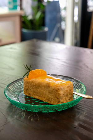 Medovik, Russian and Soviet honey cake with orange on top, served on plate