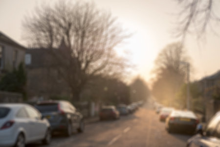 Blurred image of the street view, with car, building in background over the sunset.の写真素材