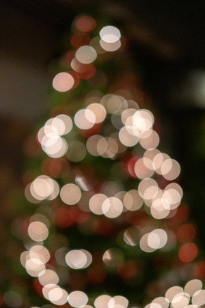 Blurred image bokeh of Christmas tree with lighting and decorationの写真素材
