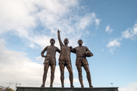 Manchester, England - 5 October 2017 : Old Trafford stadium the home of Manchester United with trio statue of George Best, Denis Law, and Sir Bobby Charltonのeditorial素材