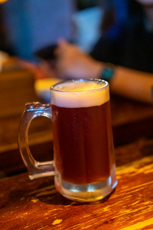 Glass of beer on the table with blur background