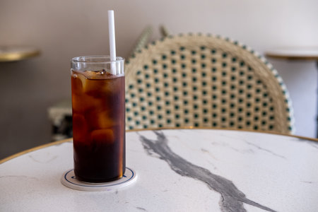 A glass of iced americano on the table