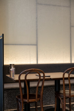 Seating inside the cafe or restaurant, with wooden chairs and table