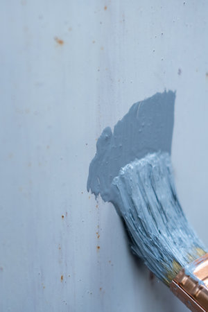 Anti-rust primer brush, on the rusty metal panelの写真素材