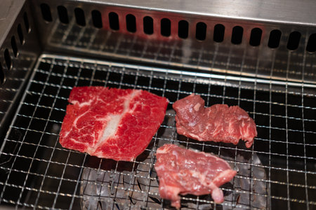 Korean Style Barbecue on stainless grill. BBQ rare meat with soft focusの写真素材