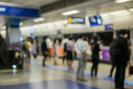 blurred image of people queue, waiting in line in mrt train station, in Bangkok, Thailand