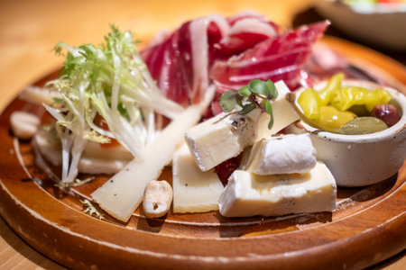 Cold cuts platter, variety of sliced meat and cheese with olives and nutsの写真素材