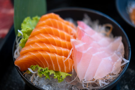 Sashimi set with vegetable served on bowl with ice, in a restaurantの写真素材