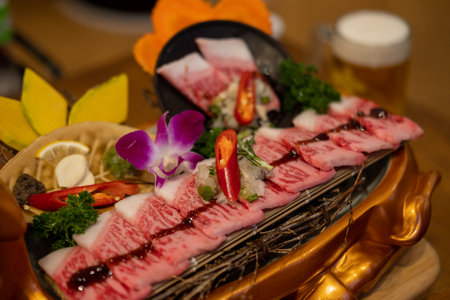Japanese style sliced beef prepared on the plate, with flower decorationの写真素材