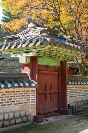 Korean traditional stone wall in Changdeokgung palace with beautiful autumn foliage.の写真素材