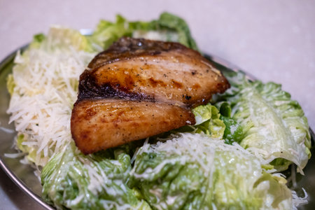 Grilled fish salad with sauce served on plate