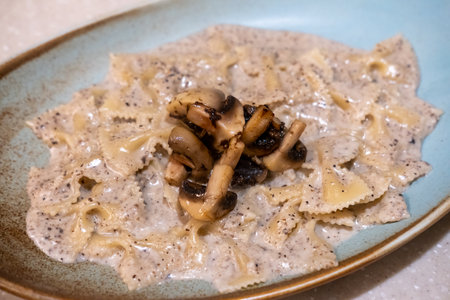 Farfalle truffle pasta served on plate. It is a pasta shaped like butterfly or bow tieの写真素材