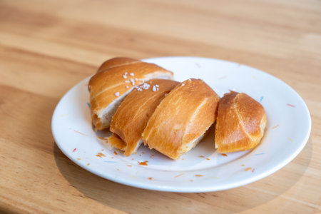 Sliced salted bread served on plate, on the wooden tableの写真素材
