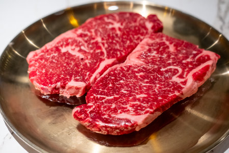 Raw Sirloin Hanwoo Beef, marbled Korean Style Meat prepared on the plateの写真素材