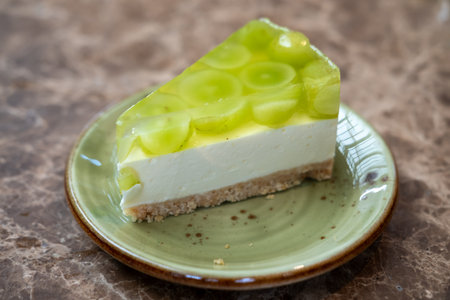 Shine Muscat grape jelly, on top of cheesecake with crumble base served on plateの写真素材