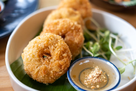 Thai style deep fried shrimp cake served on plate with sauceの写真素材