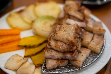 Grilled Samgyupsal, a popular Korean dish consisting of thick, sliced pork belly cooked on the grillの写真素材