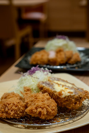 Cheese tonkatsu pork cutlet with shredded cabbage served on plate