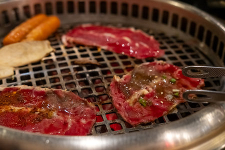 Sliced brisket on the  grill. BBQ rare meat with soft focusの写真素材