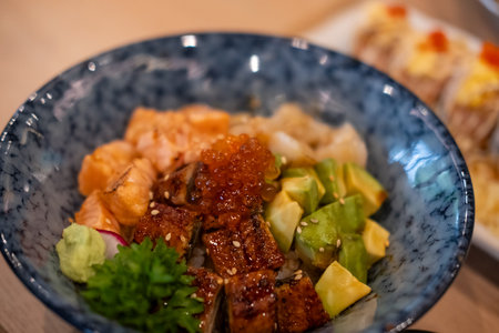 Donburi, a Japanese rice bowl dish of seafood. Including raw fish such as Salmon, Ikura, Unagi, and...