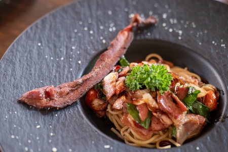 Spaghetti spicy bacon served on plateの写真素材