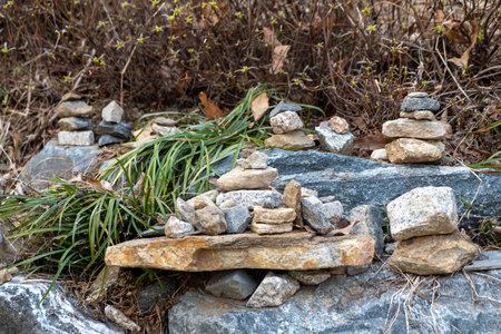 Stone pile in a temple. It is believed that stacking the stones will bring good fortune to the...