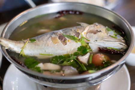 Mackerel tom yum, a spicy and sour Thai soup featuring mackerel, herbs, and aromatic spices.の写真素材