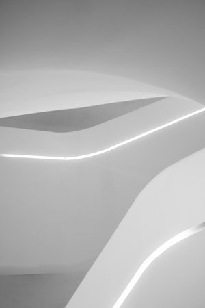 Abstract minimalist architectural detail with curved lines and integrated LED lighting.