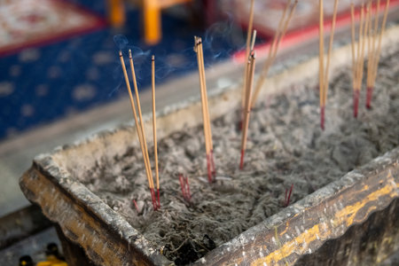 Burning incense in a pot in Thai Buddhist temple.の写真素材