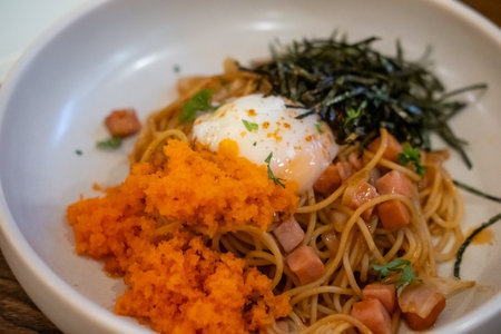Spaghetti with tobiko, egg, and seaweed served on plate