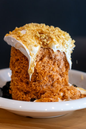Thai tea bingsu served with grass jelly and whipped cream