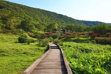 Beautiful mountain scenery with wooden path and pavilionsの写真素材