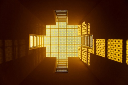 Looking up at a yellow glass roofの写真素材
