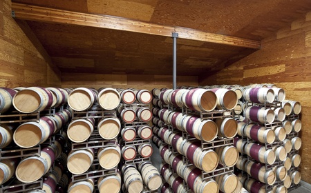 A large warehouse of wine barrels in a controlled cellarの写真素材