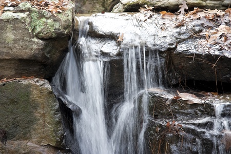 A closeup of water flowing over some rocksの写真素材