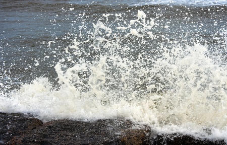 Ocean waves crashing onto some rocksの写真素材