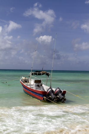 A boat ready to go out to sea by the beachの写真素材