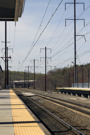 Empty electric rail road train tracks and platformの写真素材