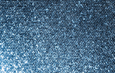 Silver fabric made of a grid of sparkling sequins.