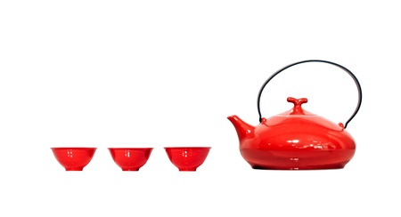 Red vintage kettle and three teacups isolated on white background. Clipping path included.の写真素材