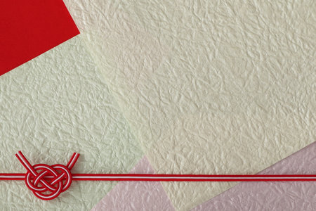Handmade Japanese knot on a colored paper background. Copy space.の写真素材