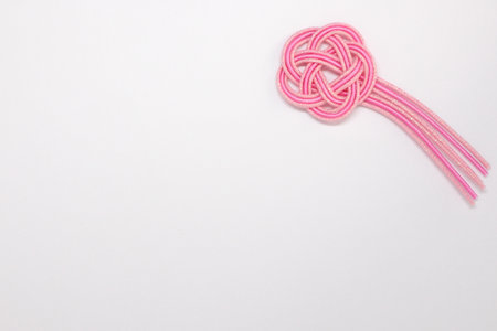 Pink-color Japanese knot ornament on white background.の写真素材