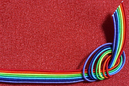 Rainbow color ornament with red color background. Place for text.の写真素材