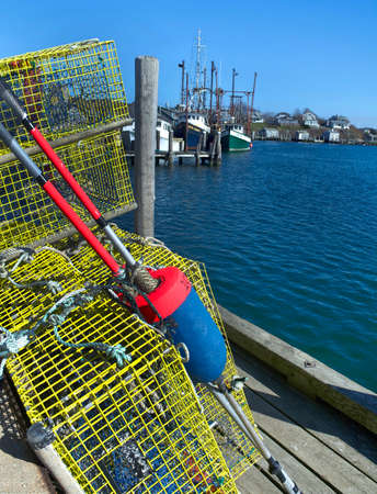Fishing nets and floats on a jetty in the harbor.