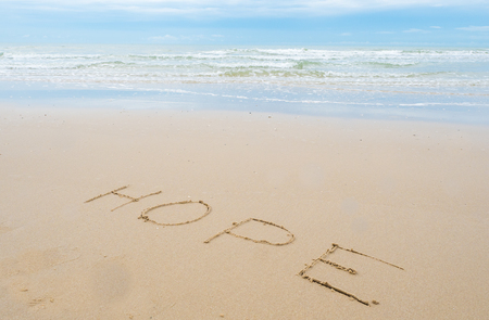 written "hope" on the beachの写真素材