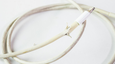 Closeup the Broken Smart Phone Charger Cable on white background