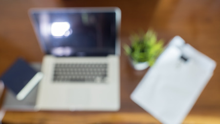 Blur Computer Laptop Research Working Desk Concept with smart phoneの写真素材