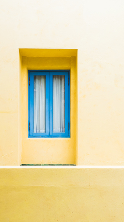 Blue window and  on yellow grunge wall background